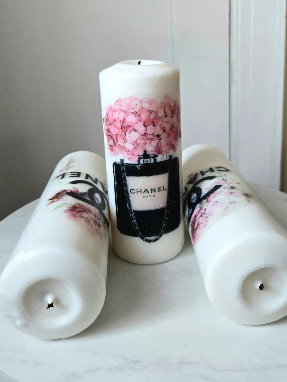 White Pillar Candles with Pink Floral Motif and Black Logo